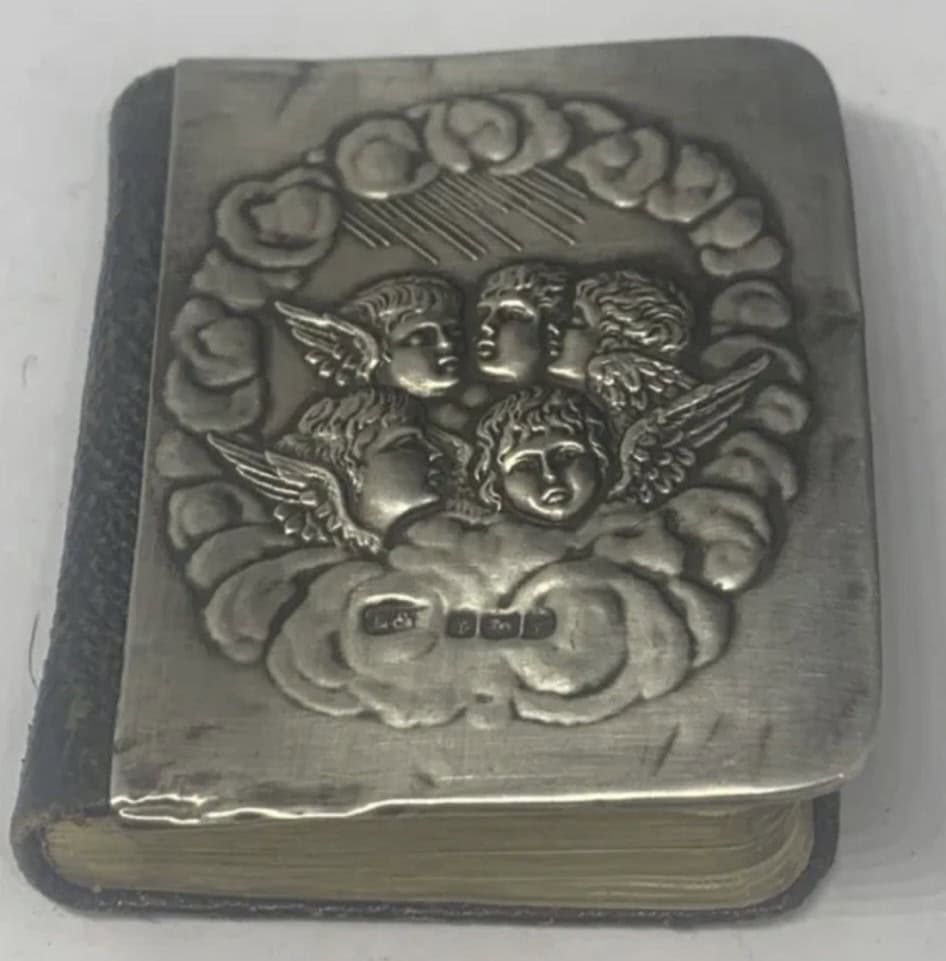 A HALLMARKED BIRMINGHAM SILVER FRONTED MINIATURE PRAYER BOOK SOLD